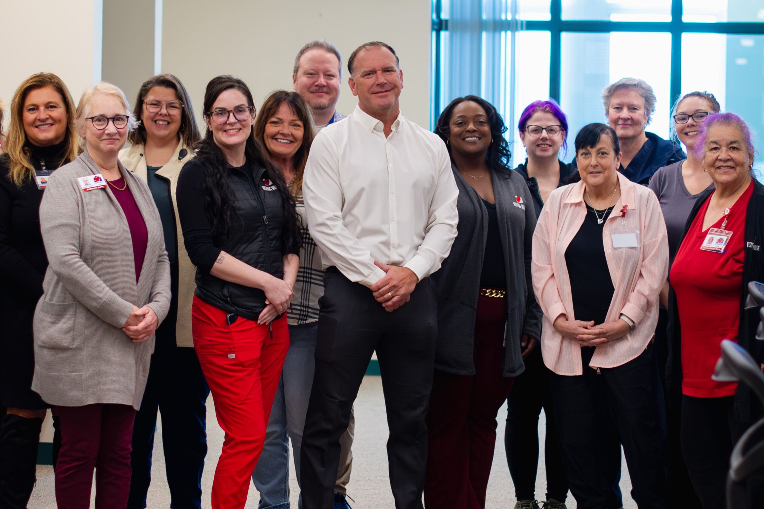 VNA's Medical Director, Mark A. Wiles, MD, Stands with members of the Hospice team and other VNA staff.